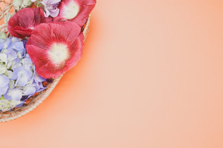 A studio shot of bright flowers in a small basket