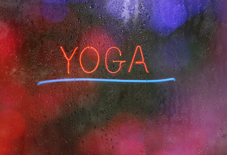 Vintage Neon Yoga Sign on Black Backgroundの写真素材