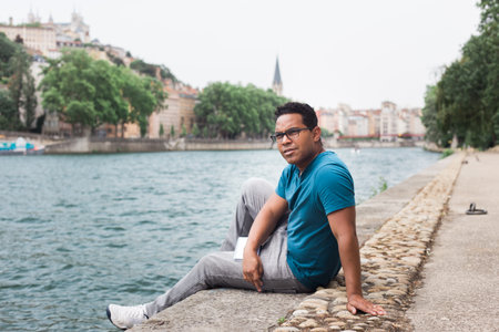 A latin man of tourist in Europe on the edge of the riverの写真素材