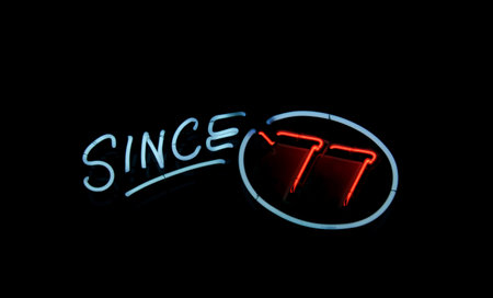 Vintage Neon 77 Sign on Restaurant Windowの写真素材