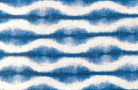 Blue and white fabric with wavy design. Textile texture background. Abstract backdrop.の写真素材