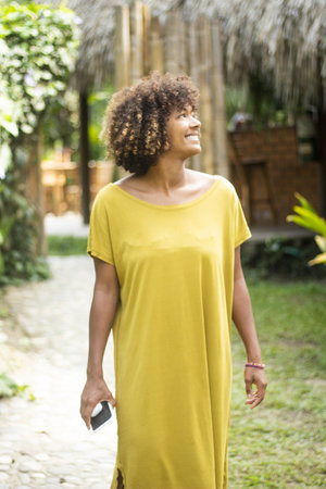 A beautiful female in a beautiful yellow dress on the beach