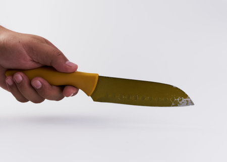 A person holding a knife isolated on a white background