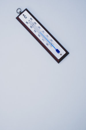 A top view of a thermometer on blue surface with a copy space
