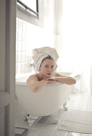 relaxed young woman in bathtub