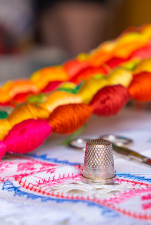 Close-up of a thimble, sewing scissors, threads and hoop. Sewing and tradition. Home hobbies authentic. The arts authentic hobbyの写真素材