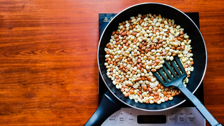 roasting peanuts in a frying pan on a induction cookwareの写真素材