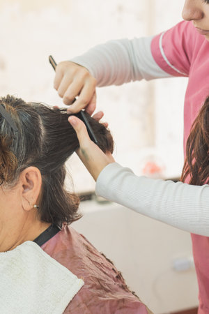 Adult woman getting a haircut. In a specialized beauty and spa center.の写真素材