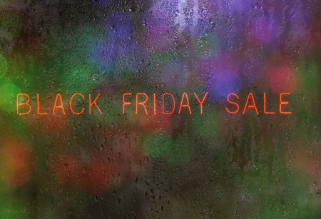 Neon Sign Black Friday Sale in Rainy Windowの写真素材