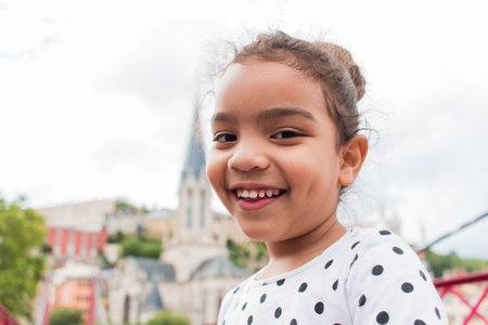 A portrait of little girl playing on a bridge on vacation in europeの写真素材