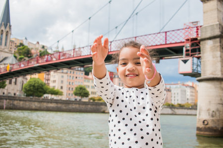 A little girl playing in the city of lyonの写真素材