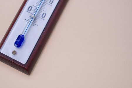 A] thermometer on cream surface with a copy space