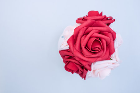 A closeup shot of red and pink roses on a clear surfaceの写真素材