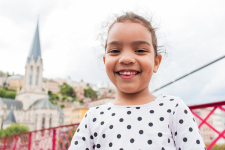 A portrait of little girl playing on a bridge on vacation in europeの写真素材