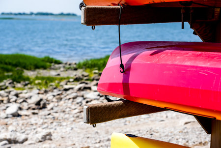Kayaks on stand near water on beachの写真素材