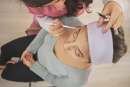 Young woman getting ready to put on makeup for a special event. In a makeup center enjoying this day.の写真素材