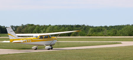 Yellow and white airplane moving toward the runway for take-off in Hanover, Ontario, Canada on a...