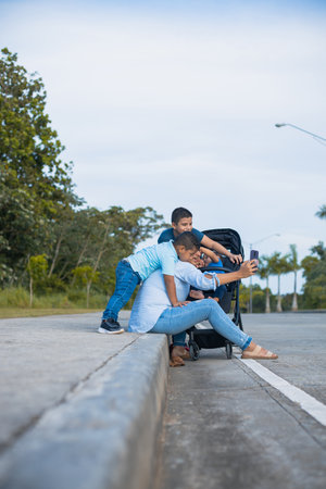 Latina mom trying to take a picture with her sons on the street