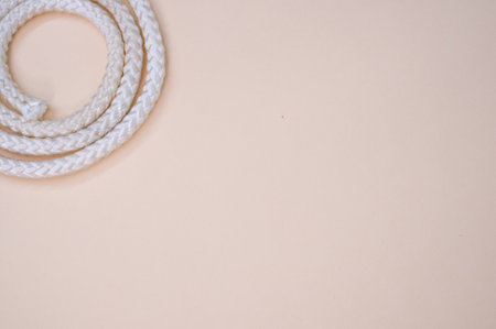 A top view of a white rope on a plain background