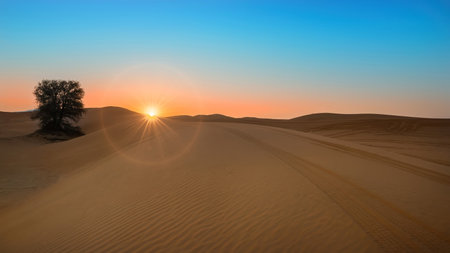 Beautiful Sunrise at desert including sand pattern with sun and shine and ringの写真素材
