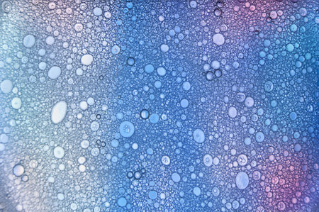 A closeup shot of water droplets on a blue background