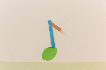 A note made of shredded paper hovers on the colored wall.