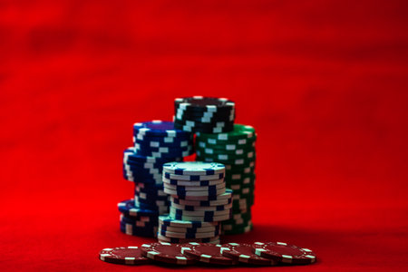 Mix of poker chips on red backgroundの写真素材