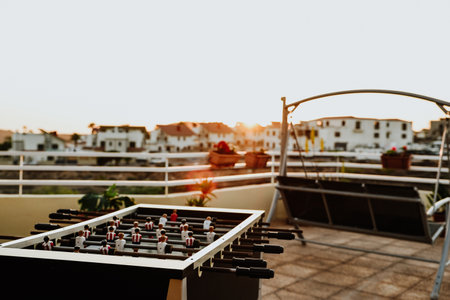 An open-air terrace with a table football and armchairの写真素材