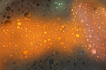 A closeup shot of water droplets on a dark colorful backgroundの写真素材