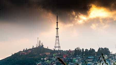 A cityscape with a high television tower on a sunset sky background