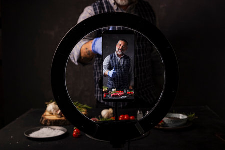 Man broadcasting a video blog about tasty and healthy food. Healthy lifestyle and social mediaの写真素材