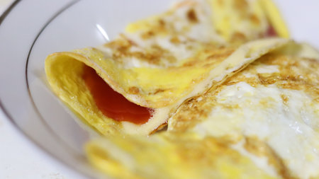 A closeup shot of a yummy omelet with tomatoesの写真素材