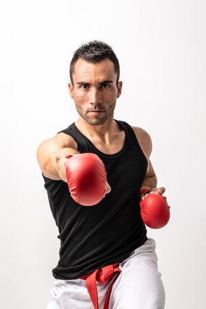 Man practicing kick boxing on white backgroundの写真素材