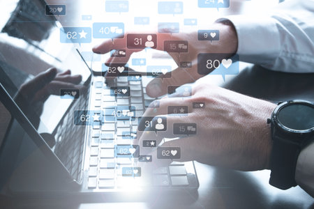 Hands typing on a laptop with social media icons - the concept of networkingの写真素材