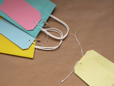 Gift bags and labels flat lay background overhead medium shotの写真素材