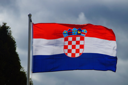 The Croatian flag flies in an allotment garden in Frankfurt on a stormy day. In the multicultural...