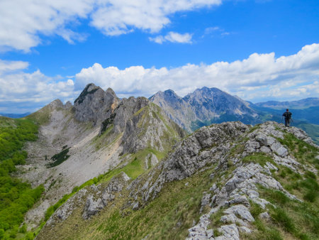 A wonderful natural landscape with a man hiking in the mountainsの写真素材