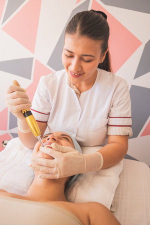 Young Woman Enjoying a Day at the Spa. Performing different treatments for the care of your skin and face.の写真素材