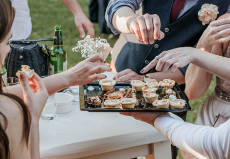 People taking canapes from tray at wedding reception.の写真素材