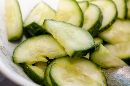A closeup shot of cut cucumbers in the bowl for saladの写真素材