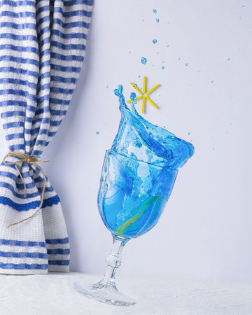 A vertical shot of blue lemonade swirling in a wine gla