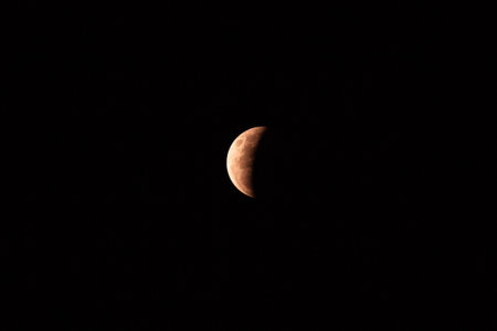 A view of the partial lunar eclipse in the dark sky