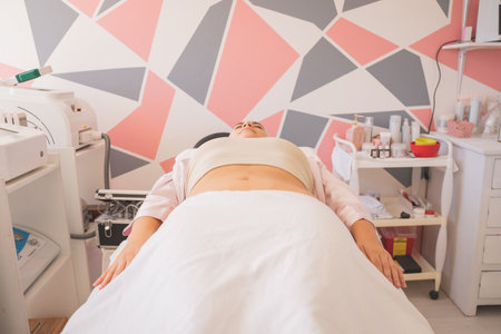 Young Woman Enjoying a Day at the Spa. Performing different treatments for the care of your skin and face.の写真素材