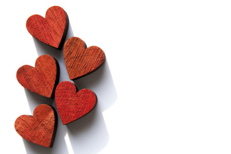A top view shot of wooden red hearts isolated on a white backgroundの写真素材