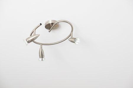 A modern curved halogen lamp on a ceiling
