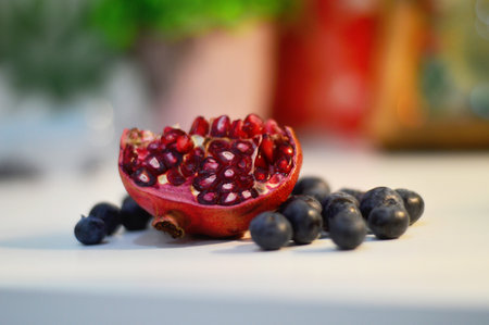 A closeup shot of ripe pomegranate and blackcurrantの写真素材