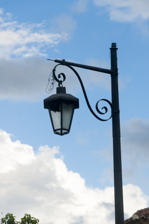 Lantern in the daylight on the street in the colonial city of La Antigua Guatemala, public lighting in an iron structure.の写真素材