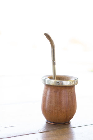 A traditional Mate caffeine-rich infused drink in a palo santo wood cup with a metal strawの写真素材