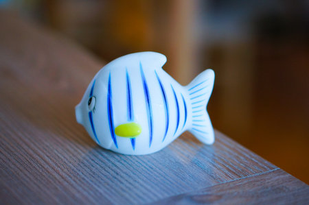 A plastic toy fish on a wooden tableの写真素材