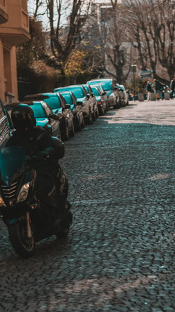 A vertical shot of a motorcyclist with a black motorcycle in a streetの写真素材